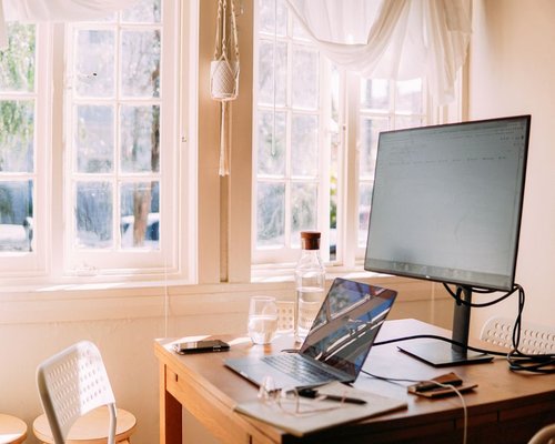 Comfortable home office setup with natural lighting coming from a window