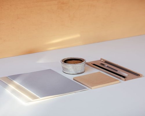 Modern office desk with a clean notebook, pen, and a cup of coffee